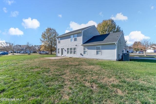 back of house with a patio, a yard, and central AC