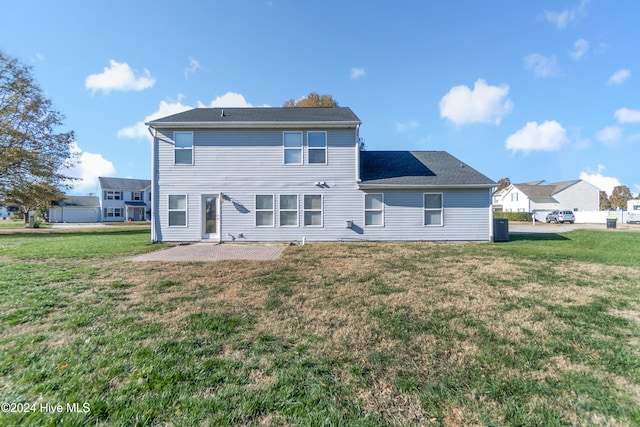 rear view of house with a patio area and a lawn