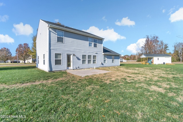 back of house featuring a yard and a patio area