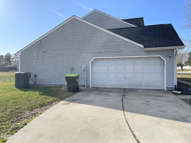 view of home's exterior featuring cooling unit, a yard, and a garage