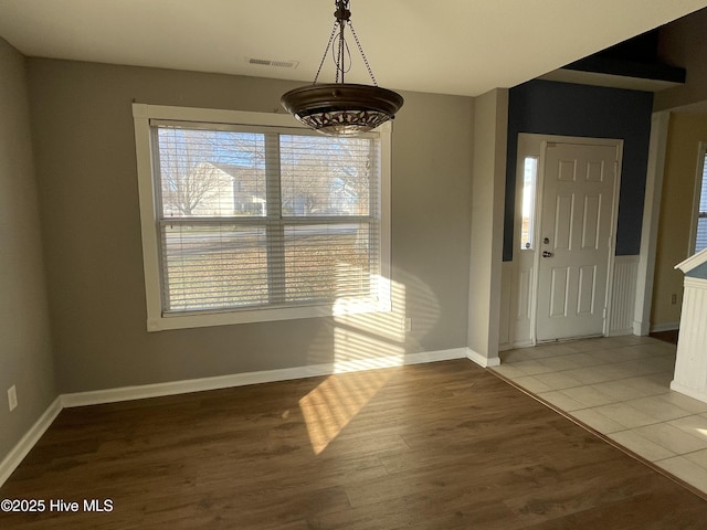 unfurnished dining area with wood-type flooring