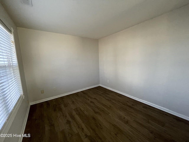 empty room featuring dark wood-type flooring