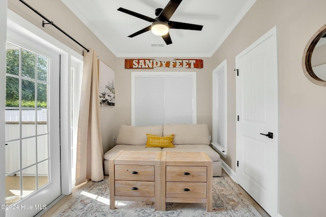 100 Gateway Condos Dr Unit 110, Surf City, NC 28445 - living area with a ceiling fan, light wood finished floors, and ornamental molding