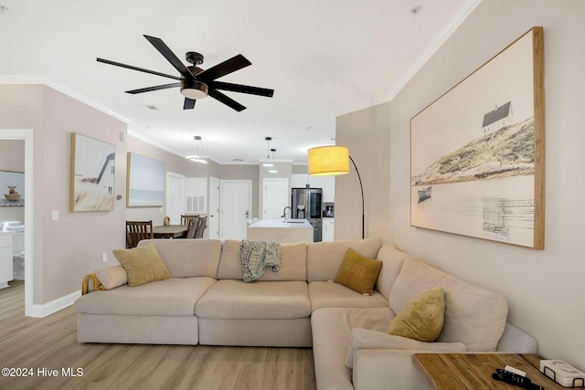 100 Gateway Condos Dr Unit 110, Surf City, NC 28445 - living area featuring light wood finished floors, crown molding, a ceiling fan, and baseboards