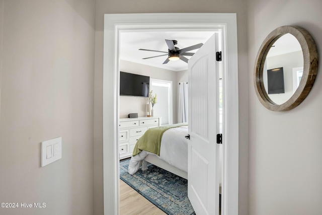 bedroom with ceiling fan, light hardwood / wood-style floors, and ornamental molding