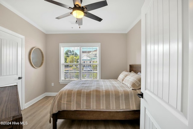 bedroom with ceiling fan, ornamental molding, and light hardwood / wood-style flooring