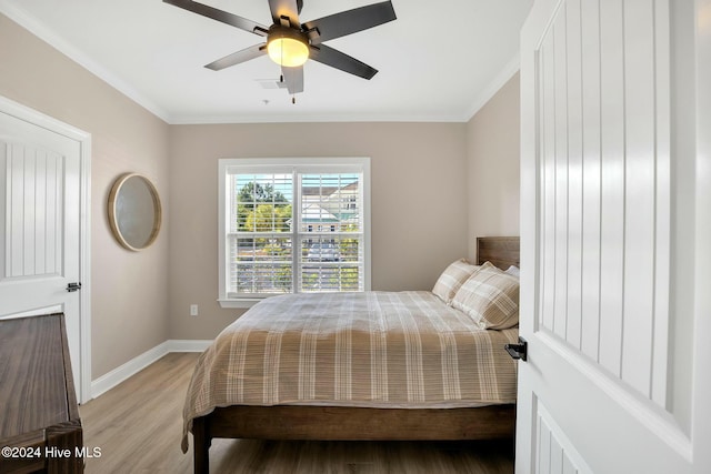 100 Gateway Condos Dr Unit 110, Surf City, NC 28445 - bedroom with light wood-type flooring, ornamental molding, baseboards, and ceiling fan