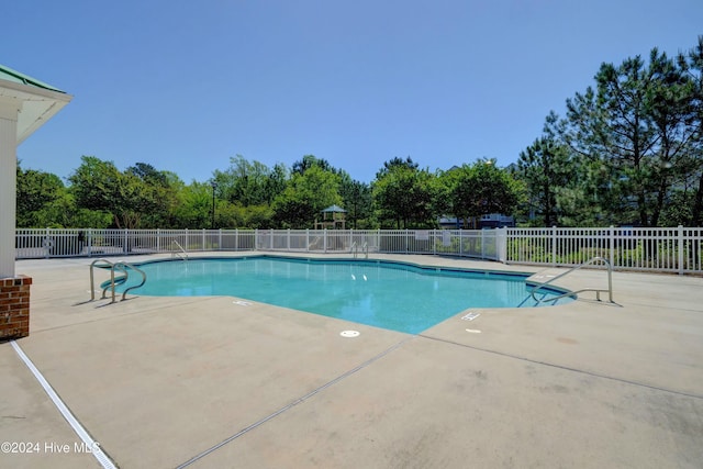 100 Gateway Condos Dr Unit 110, Surf City, NC 28445 - community pool featuring a patio and view of wooded area
