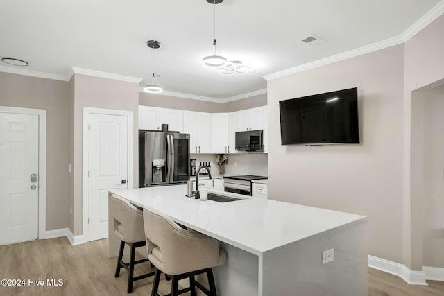100 Gateway Condos Dr Unit 110, Surf City, NC 28445 - kitchen with stainless steel appliances, a sink, light wood-type flooring, white cabinetry, and baseboards