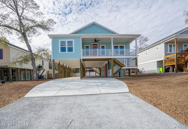 beach home with covered porch, a carport, and ceiling fan