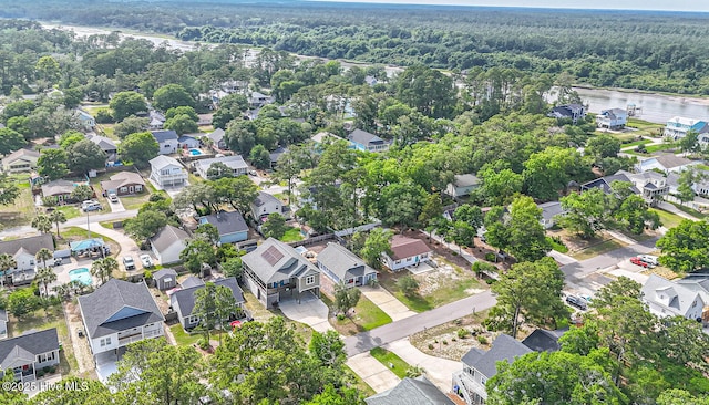 117 NW 17th St, Oak Island, NC 28465 - aerial view of property's location featuring a heavily wooded area, nearby suburban area, and a nearby body of water
