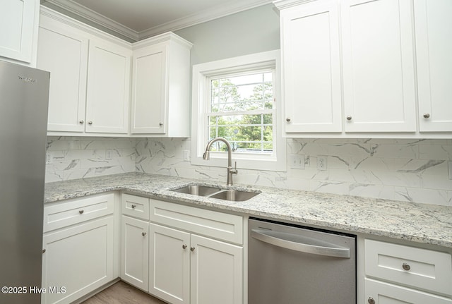 117 NW 17th St, Oak Island, NC 28465 - kitchen with stainless steel appliances, a sink, backsplash, white cabinetry, and ornamental molding