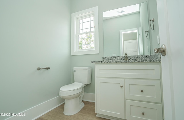 117 NW 17th St, Oak Island, NC 28465 - bathroom featuring baseboards, toilet, vanity, and wood finished floors