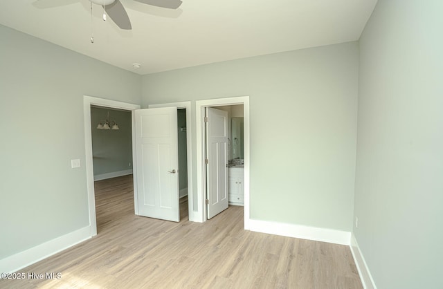 117 NW 17th St, Oak Island, NC 28465 - unfurnished bedroom with light wood-type flooring, baseboards, and ensuite bathroom