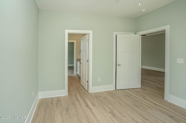117 NW 17th St, Oak Island, NC 28465 - unfurnished bedroom with light wood-style floors and baseboards