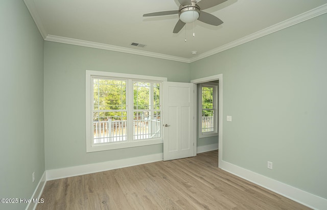 117 NW 17th St, Oak Island, NC 28465 - empty room with baseboards, crown molding, wood finished floors, and a ceiling fan