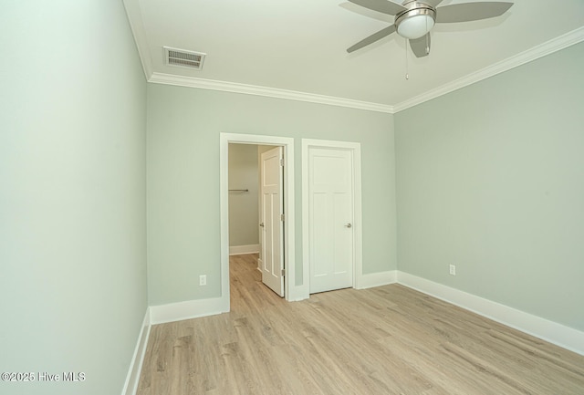 117 NW 17th St, Oak Island, NC 28465 - unfurnished bedroom featuring ornamental molding, baseboards, light wood-style floors, a closet, and a ceiling fan