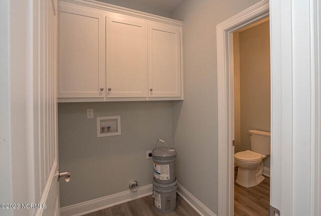 laundry area with cabinets, hookup for a washing machine, dark wood-type flooring, and hookup for an electric dryer