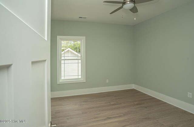 117 NW 17th St, Oak Island, NC 28465 - empty room featuring ceiling fan, wood finished floors, and baseboards