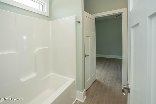 117 NW 17th St, Oak Island, NC 28465 - bathroom with wood finished floors, baseboards, and shower / tub combination