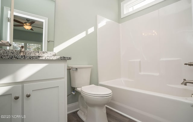 full bathroom featuring hardwood / wood-style flooring, plenty of natural light, toilet, and vanity