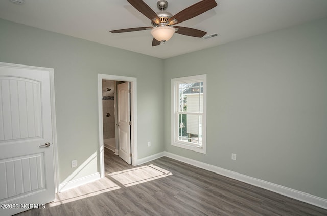 unfurnished bedroom featuring wood-type flooring, ensuite bath, and ceiling fan