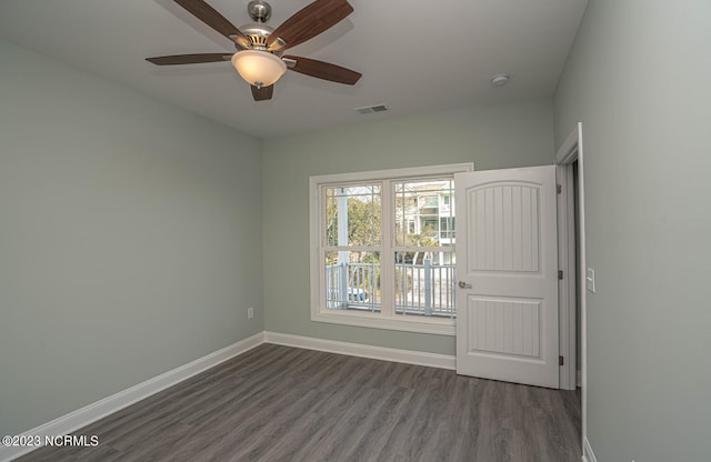 spare room featuring ceiling fan and dark hardwood / wood-style flooring