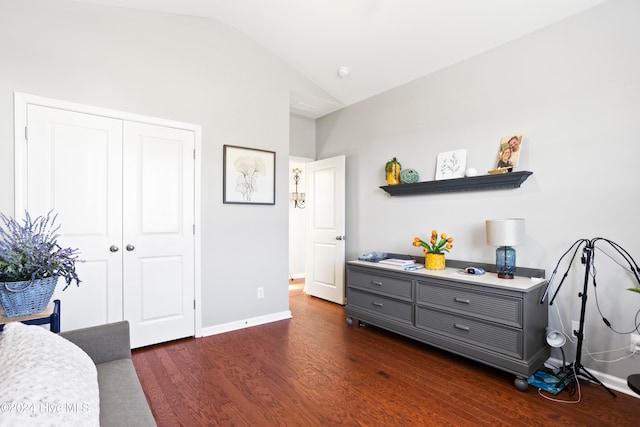 sitting room featuring dark hardwood / wood-style floors and lofted ceiling