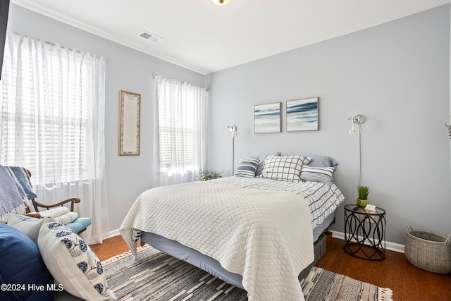 bedroom with dark hardwood / wood-style floors