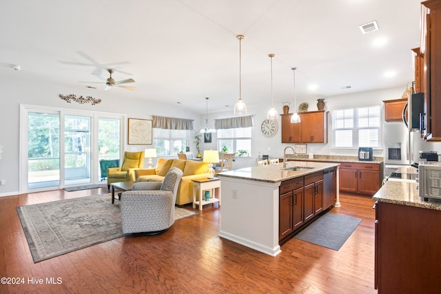 kitchen featuring hardwood / wood-style floors, plenty of natural light, sink, and a kitchen island with sink