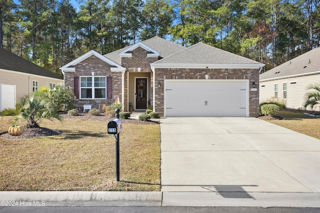 view of front of property featuring a front yard and a garage