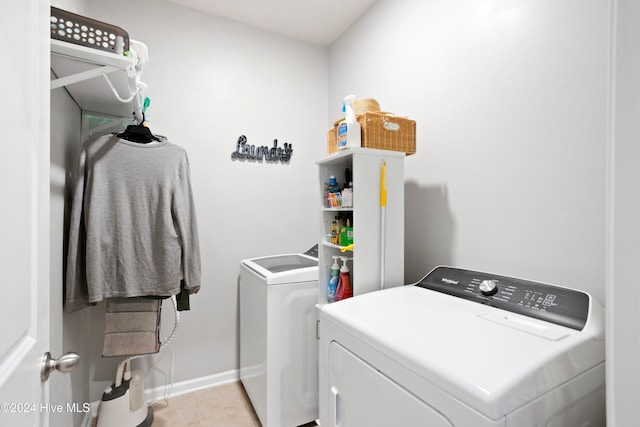 washroom featuring washing machine and clothes dryer and light tile patterned floors