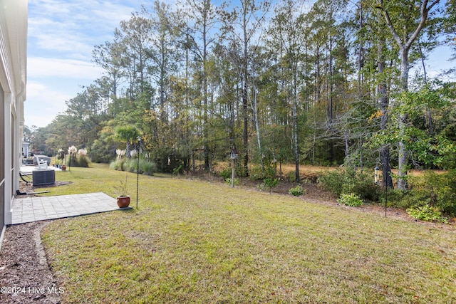 view of yard with cooling unit and a patio