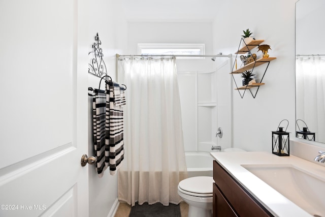 full bathroom with vanity, shower / tub combo, and toilet