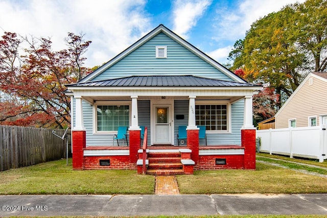 bungalow with a porch and a front yard