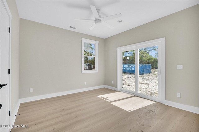 822 Kenneth Ave Unit 1, Carolina Beach, NC 28428 - unfurnished room featuring healthy amount of natural light, light wood-style floors, and a ceiling fan