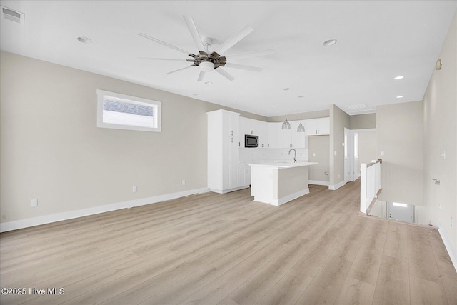 822 Kenneth Ave Unit 1, Carolina Beach, NC 28428 - unfurnished living room featuring light wood-type flooring, a ceiling fan, and recessed lighting