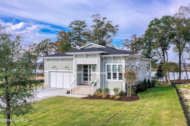 view of front of home with a garage and a front lawn