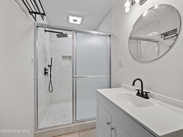 bathroom with vanity and a shower with shower door