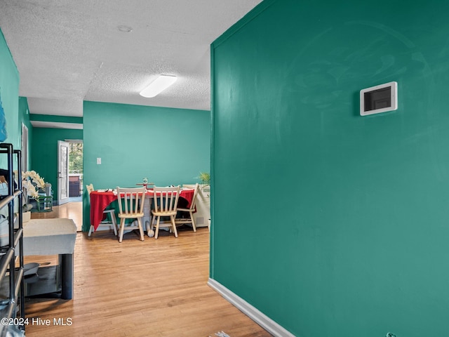 interior space featuring a textured ceiling and light hardwood / wood-style flooring