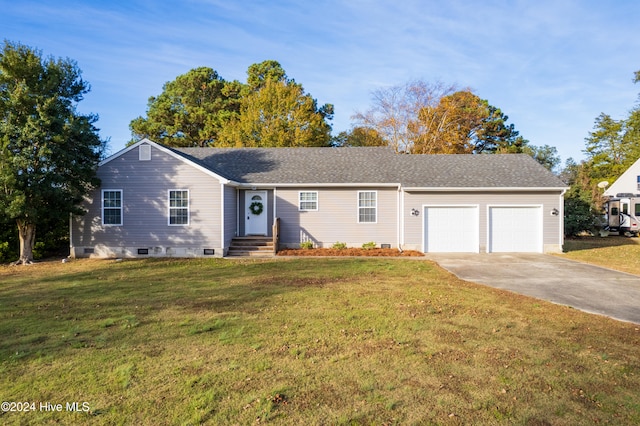 single story home with a front yard and a garage