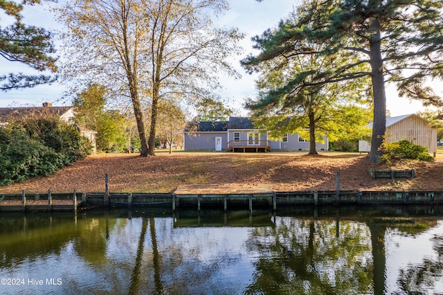 rear view of house featuring a water view