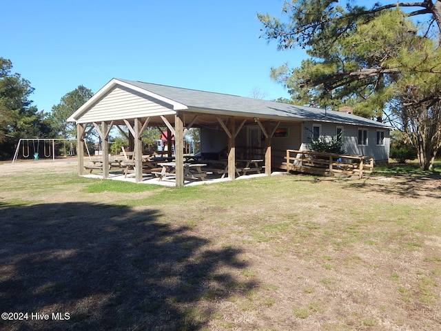 rear view of property with a playground