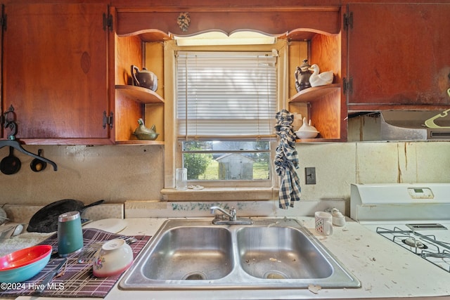 kitchen with white gas range and sink