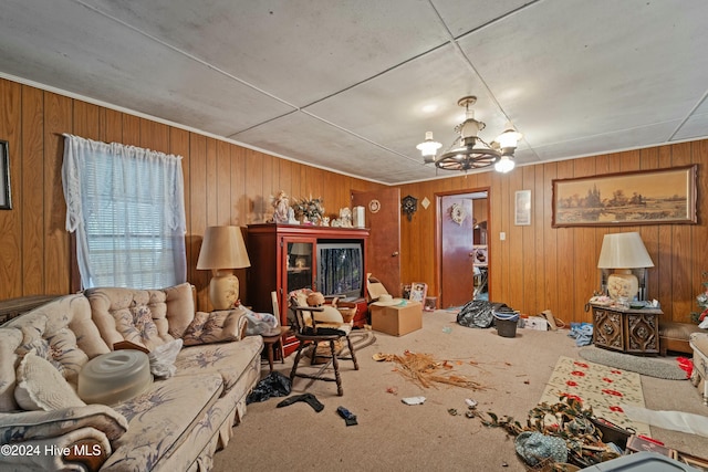 living room with carpet flooring, wooden walls, and a notable chandelier