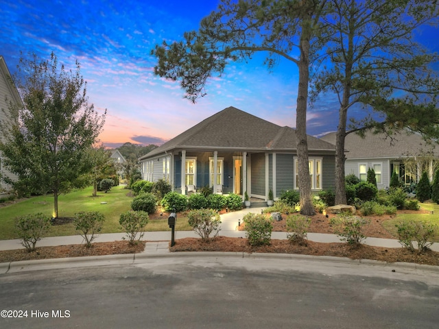 view of front of property with a lawn and covered porch