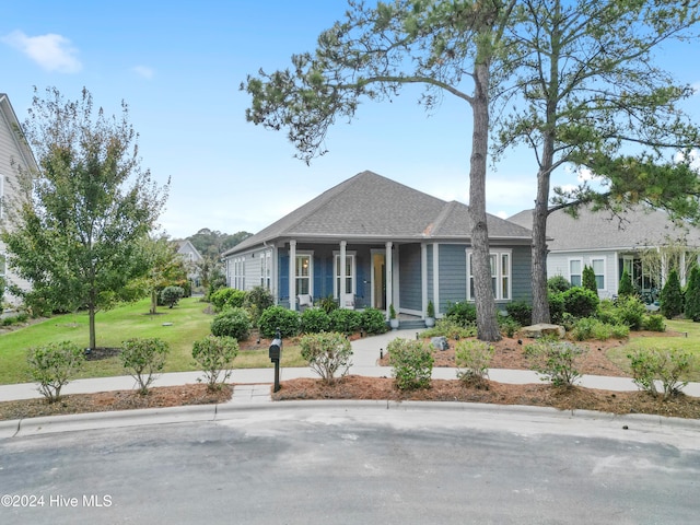 view of front of house with a front lawn and covered porch