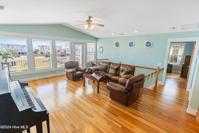 living room featuring ceiling fan, light hardwood / wood-style flooring, a healthy amount of sunlight, and lofted ceiling