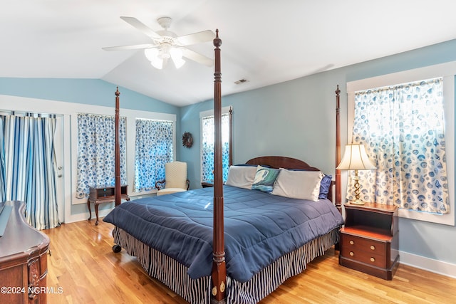 bedroom featuring ceiling fan, light wood-type flooring, and lofted ceiling