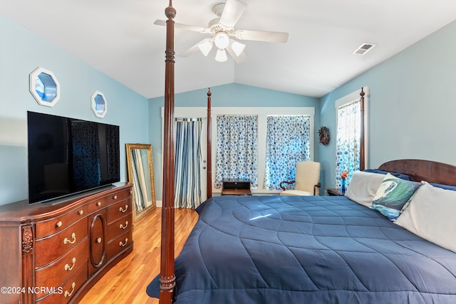 bedroom featuring ceiling fan, light wood-type flooring, and vaulted ceiling